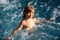 Cute boy swim in pool. Active healthy kids lifestyle, water sport activity and lessons for summer family vacation with