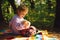 Cute Boy with teddy bear sit on park. Happy kids. Cute picture for childrens ads. Freedom Concept.