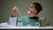 Cute boy use pipette in chemistry lab at pupil table. Child doing chemical research laboratory pipette in home schooling