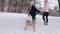 Cute boy in warm clothing walk with his mother pulling wooden vintage sled on snowy winter day. Little guy sledding in
