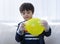 Cute boy wearing disposable protective plastic glove and holding yellow balloon,Kid preparing science project about static charged