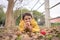 A cute boy in winter coat colour yellow lying down on the autumn leaves and eating apple in the winter. Simple living joy of rural