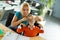 Cute boy and woman sit at the desk in the office and play