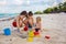 Cute  boys playing with beach toys on tropical beach