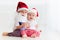 Cute brother siblings, kids in santa`s hats and garland playing at home