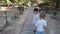 Cute brothers, toddler and 4 year old walking on the wooden patio in the park.