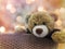 Cute brown bear doll gift in basket on romantic bokeh sweet love