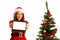 Cute brunete girl in santa claus dress with presents for christmas