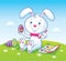 Cute Bunny Painting Easter Eggs On Grassy Hilltop