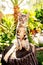 Cute calico cat on a log in a garden