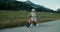 Cute carefree toddler girl ride on bicycle on country road at summer vacation