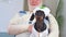 Cute caring nurse dog in cap, uniform, bandaged man in cast with head injury