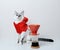 Cute cat in red Christmas hoodie on a white background. With pour over dripper. Coffee brewing. Free space, isolated