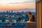 Cute cat sitting in a balcony looking over city skyline Generative Ai