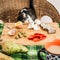 Cute cat stealing cheese from a table.