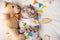 Cute cat with a teddy bear, on a light background with toys. Funny animals, with space for an inscription. Sweet dream