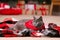 Cute cat wearing bandana on plaid in room decorated for Christmas