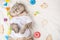 Cute cat in a white T-shirt with children`s toys. Sweet kitten, banner for design,top view