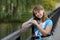 Cute caucasian brunette girl leaning on railing