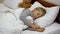 Cute Caucasian child sleeping in bed at home. Portrait of charming boy lying in bedroom with teddy bear at background