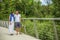 Cute Caucasian couple hanging a lock on the bridge as a sign of eternal love