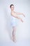 Cute caucasian girl in ballet clothes learning to be a ballerina on a white background in the Studio. plus size young woman dreams