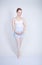 Cute caucasian girl in ballet clothes learning to be a ballerina on a white background in the Studio. plus size young woman dreams