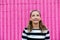 Cute caucasian girl celebrating her 13th birthday teenager standing in front of a hot pink wall outside