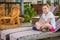 Cute Caucasian girl sitting on a reclining wooden chair