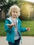 Cute Caucasian preschool girl holding rain worm in hands. Child kid learning studying nature around. Natural biology science.