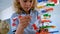 Cute Caucasian schoolgirl studying DNA model in classroom at school