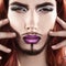 Cute charming male model with magenta makeup looking at camera