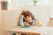 cute cheerful curly boy sitting in cafe with piece of cake