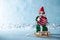 Cute Cheerful Santas Helper Elf Loading Christmas Bauble Onto Santas Sleigh. North Pole Christmas Scene. Santas Workshop.