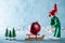 Cute Cheerful Santas Helper Elf Pulling Santas Sleigh With Christmas Bauble.North Pole Christmas Scene. Santas Workshop.