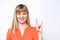 Cute cheerful woman showing the peace / victory hand sign against white background.