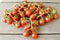 Cute cherry tomatoes on wooden background