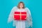 Cute child angel with gift box present. Valentines day banner. Cute child with angel wings. Studio portrait of angel