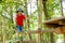 Cute child, boy, climbing in a rope playground structure