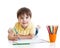 Cute child boy drawing with pencils in preschool
