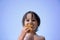 Cute child, boy, eating croissant on the beach