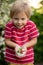 Cute child, boy, eating small cupcake of Pavlova desert, light egg and sugar desert with cream and strawberries