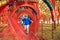 Cute child boy overcomes obstacles in rope tunnel outdoors. Modern amusement park for kids. Healthy and happy childhood