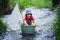 Cute child, boy, playing with boat and ducks on a little rive