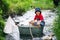 Cute child, boy, playing with boat and ducks on a little river