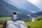 Cute child, boy sitting on a car ceiling, meditating enjoying the quietness of nature, travel on the road to scenic mountains