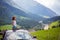 Cute child, boy sitting on a car ceiling, meditating enjoying the quietness of nature, travel on the road to scenic mountains