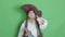 Cute child dressed as pirate showing thumb up. Isolated on green screen slow motion