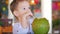 Cute child drinks a coconut trough a straw, close-up. Concept: children, happy childhood, summer, baby, vacation.