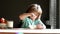 Cute child eating breakfast at home. Kids eat porridge and milk for morning breakfast.